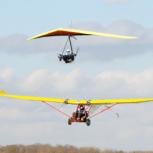 The E-Lazair electric aircraft and the E-Dragonfly hang-glider, low level flypast in formation at Sywell Aerodrome