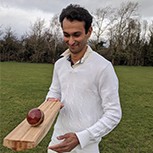 A close-up of a cricket batting pad being used during play, alongside a photo of Dr Shah wearing cricket gear.