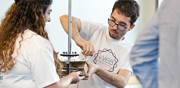 MET students Elena Odysseos and Ioannis Menicou demonstrate the WEB Composites team's weaving machine.