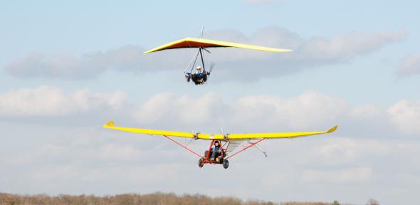 The E-Lazair electric aircraft and the E-Dragonfly hang-glider, low level flypast in formation at Sywell Aerodrome