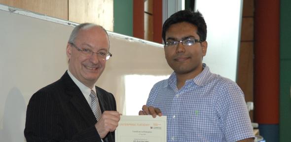 Mash-Hud Iqbal receiving the Certificate in Enterprise with distinction from Professor Arnoud De Meyer