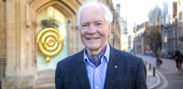 Dr John C Taylor in front of the popular Corpus Chronophage Clock, that he created and donated to his former college 