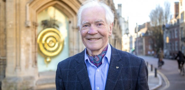 Dr John C Taylor in front of the popular Corpus Chronophage Clock, that he created and donated to his former college