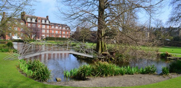 A bridge being constructed for the Emmanuel College May Ball. It is a steel channel arch adorned by a tensegrity arch. Tensegrity structures rely on prestress stability for stand up. 