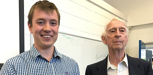PhD student Lachlan Jardine accepts the Department's Helios Prize from donor John Firth.