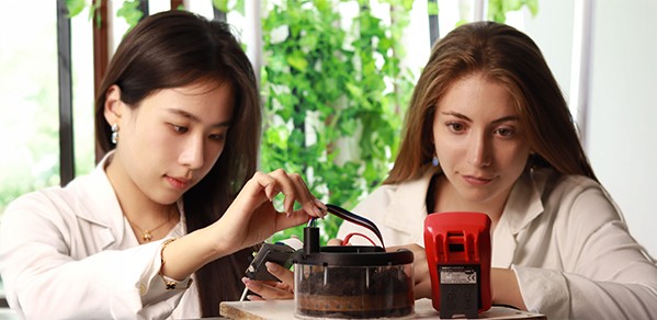 Using a non-vision-based sensor system and EIT technology, PhD students Xiaoxian (Amanda) Xu (left) and Catherine Merchant measure electrical signals in soil to investigate its internal properties