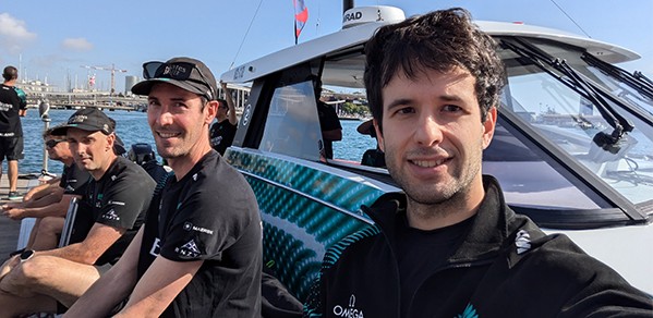 Alumni Simon Corkery (second left) and Ignacio Andreu Angulo (right) are part of Emirates Team New Zealand (ETNZ).