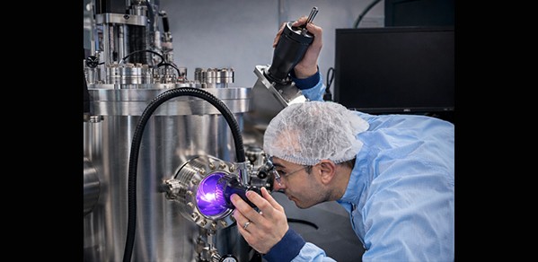 Dr Bakhit looking into the growth chamber during the Hf(Sr,Ti)O2 co-sputtering
