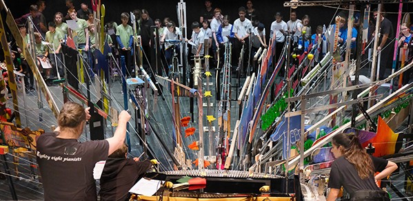 Apprentice Catia (bottom right) checks the mechanisms are working correctly during the 88 Pianists rehearsal.