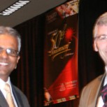 Dr O'Neill (right) receiving his award from the President Dr Raj Patel