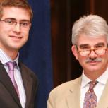 Andrew Jackson (left) receiving his prize certificate from ICE Director General Tom Foulkes