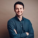 A headshot of Alex Kendall with his arms folded. Next to him is a wide team shot of Wayve staff standing in front of Wayve cars.