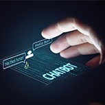 Human hand lit up by a smartphone displaying a chatbot interaction.
