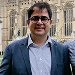 Co-founder of Neela Biotech Dr Deepanshu Singh holds his winner's certificate while standing in the grounds of King's College, C