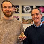 PhD student Jack Peden is seen accepting his Helios-inspired brass medal from the Head of the Department