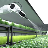 Smart robotic farmer spraying fertiliser on vegetable green plants