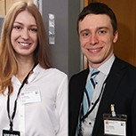 PhD students Teja Potočnik and David Hardman stand next to their research posters.