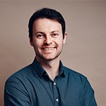 A head and shoulders shot of Alex Kendall. Next to him is an image of Big Ben at night with the road visible in front of it. Car