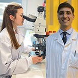 Dr Amparo Güemes using a microscope in the Bioelectronics Lab and Ruben Ruiz-Mateos Serrano is seen holding one of his devices