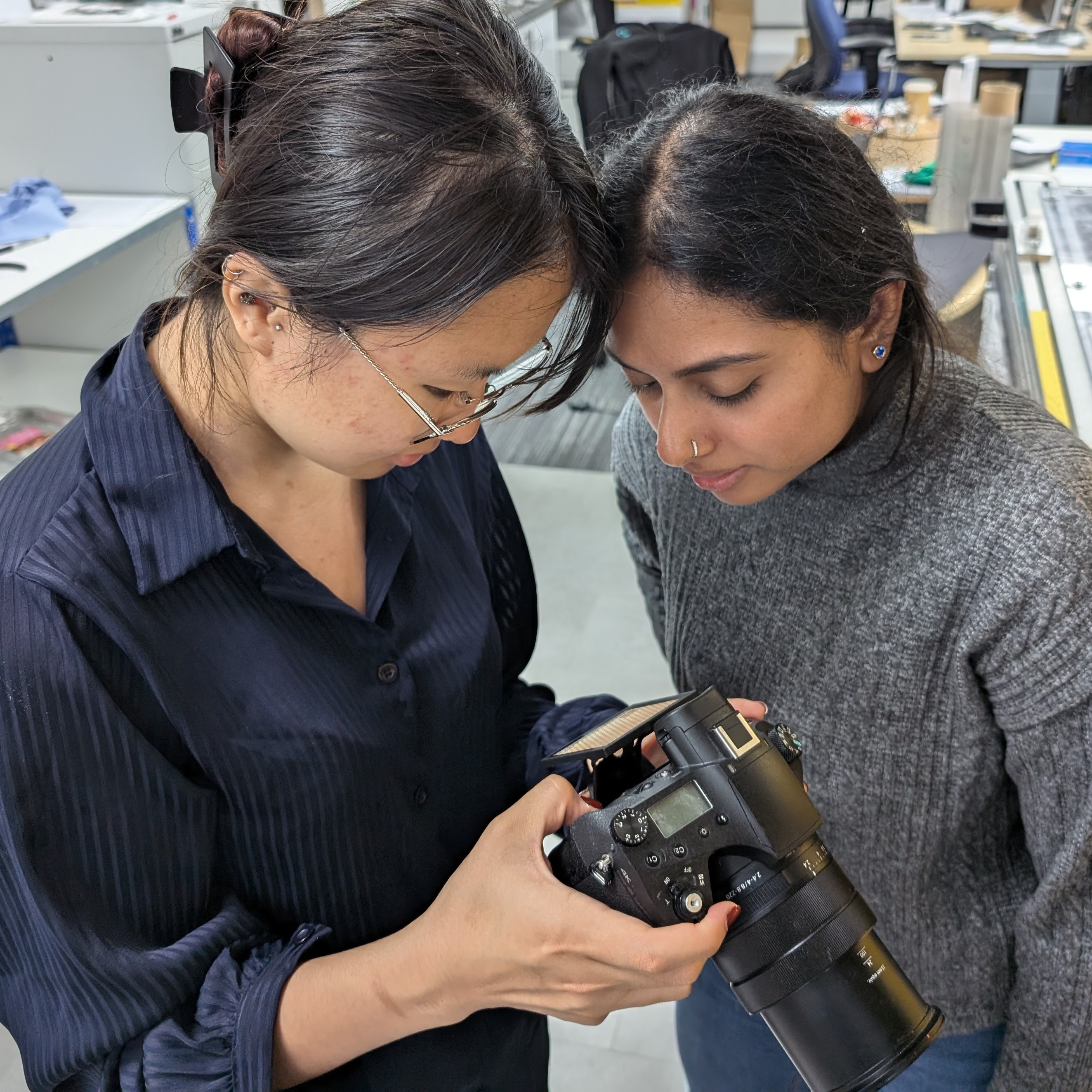 Changyue (left) and colleague looking at a video of the Powerdrop coating