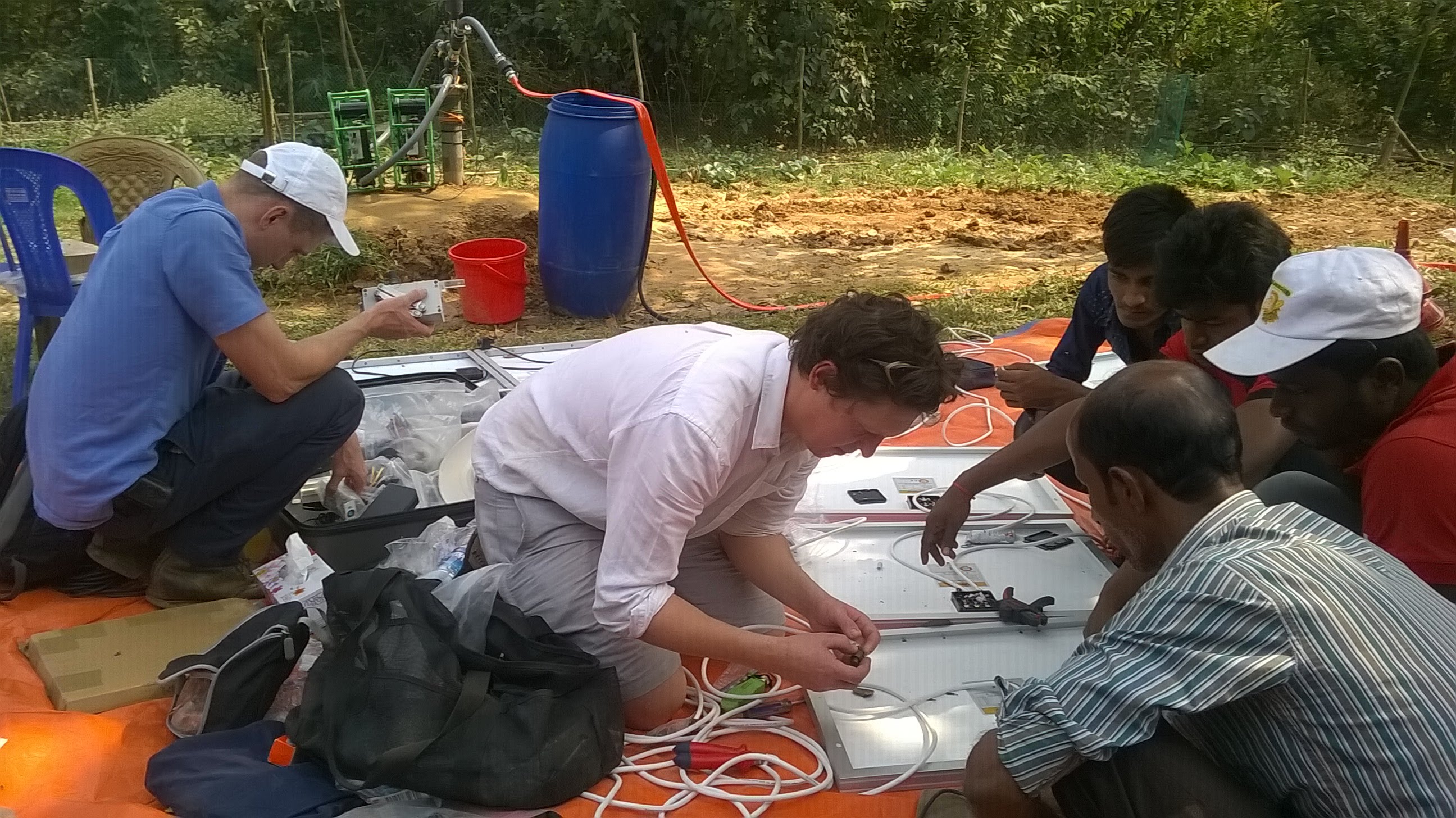 Tom re-wiring PV modules prior to setting up a trial delivering water to a vegetable garden beside a mosque in Hemayetpur, nr. Dhaka, Bangladesh, February 2018. With colleague Cai Williams and technical team members from IDE (International Development Enterprises), Bangladesh