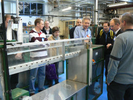 Teachers looking at an experiment on open-channel water flow.