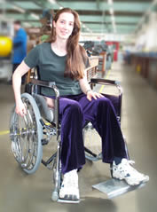 Lucy Porter demonstrating the wheelchair design.